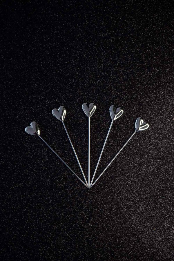 Sparkling silver heart cocktail sticks for elegant entertaining and fancy drinks, ideal for parties and special occasions.