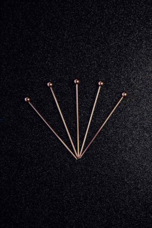 Elegant cocktail sticks adorned with pink pearls, perfect for stylish entertaining and adding a touch of luxury to your drinks. Ideal for parties and special occasions.