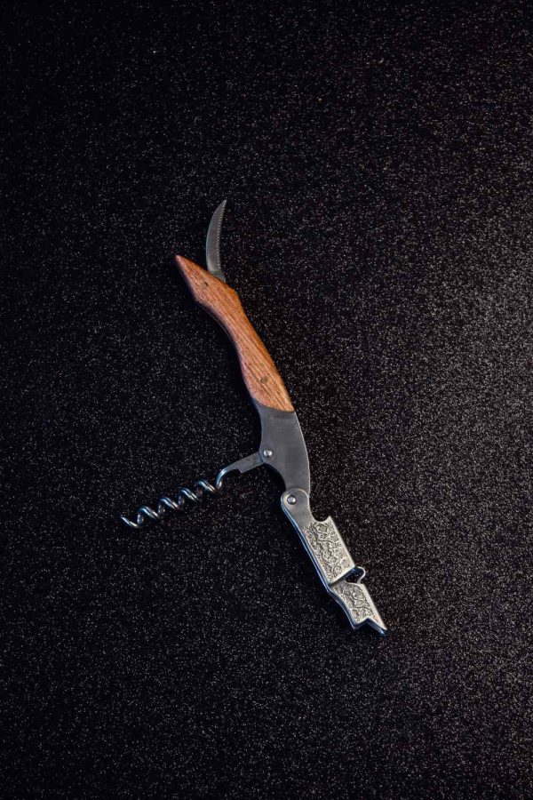 Sophisticated waiter's corkscrew with elegant wooden handle for effortless uncorking of fine wines. Perfect gift for wine enthusiasts.