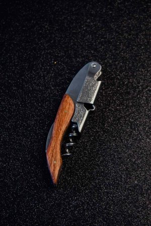 Sleek and durable waiter's corkscrew featuring a luxurious wooden handle for effortless wine opening. Perfect for wine enthusiasts.